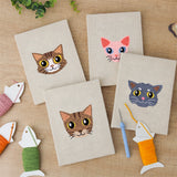 The four finished Tabby Cat Faces mini canvases laid out on a table