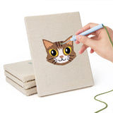 Hand punching one of the Tabby Cat Faces mini canvases