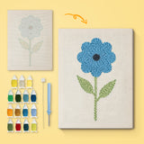 Tall Blue Flower canvas before and after punching, with the threads and tools