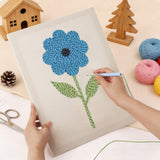Punching the Tall Blue Flower design with the punch needle