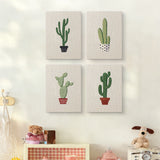 The four Tall Potted Cacti mini canvases on a wall above a shelf