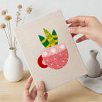 Hand holding a finished Teacup Succulents mini canvas