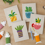 The four finished Teacup Succulents mini canvases laid out on a table