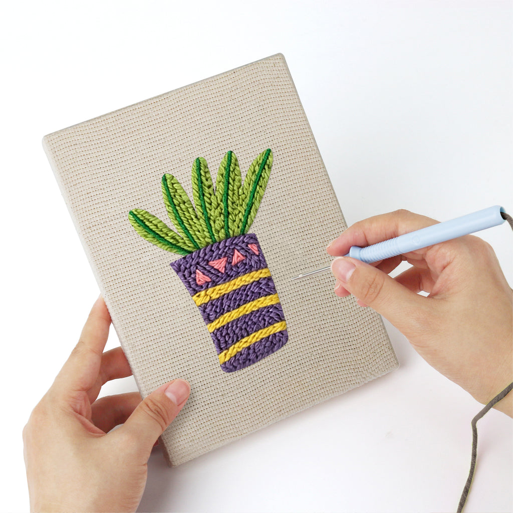 Punching a Teacup Succulents mini canvas with the punch needle