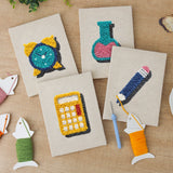 The four finished Teal Alarm Clock mini canvases laid out on a table