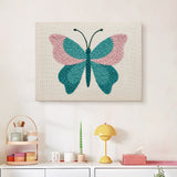 Finished Teal Blush Butterfly punch needle canvas on a wall
