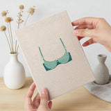Hand holding a finished Teal Bralettes mini canvas