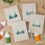 The four finished Teal Bralettes mini canvases laid out on a table