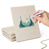 Hand punching one of the Teal Bralettes mini canvases