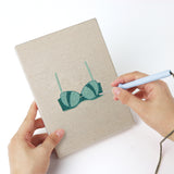 Punching a Teal Bralettes mini canvas with the punch needle