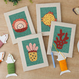 The four finished Teal Coral Reef mini canvases laid out on a table