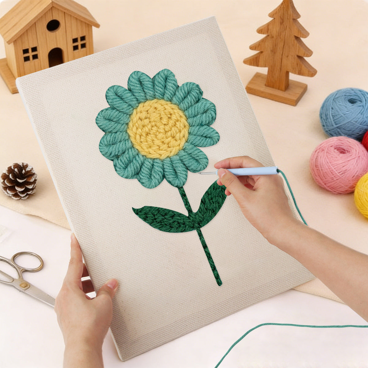 Punching the Teal Daisy design with the punch needle
