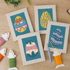 The four finished Teal Easter Eggs mini canvases laid out on a table