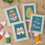 The four finished Teal Easter Eggs mini canvases laid out on a table