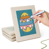 Hand punching one of the Teal Easter Eggs mini canvases