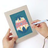 Punching a Teal Easter Eggs mini canvas with the punch needle