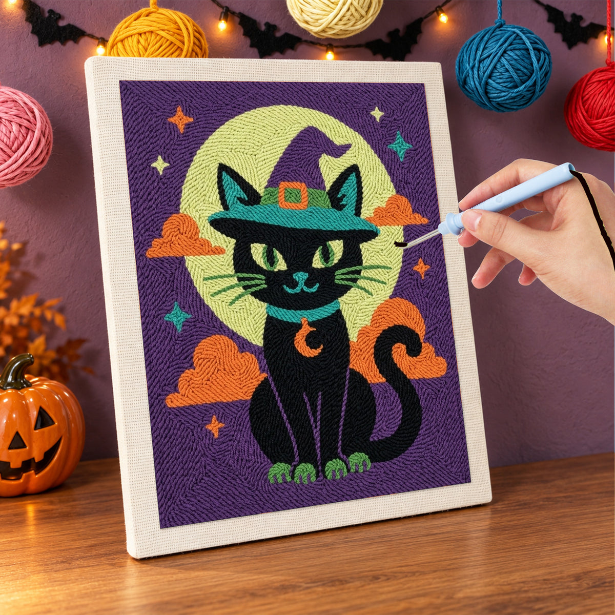 Punching the Teal Hat Black Cat design with the punch needle