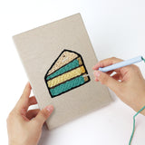 Punching a Teal Layer Cake mini canvas with the punch needle