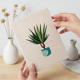 Hand holding a finished Teal Pot Greens mini canvas