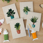 The four finished Teal Pot Greens mini canvases laid out on a table