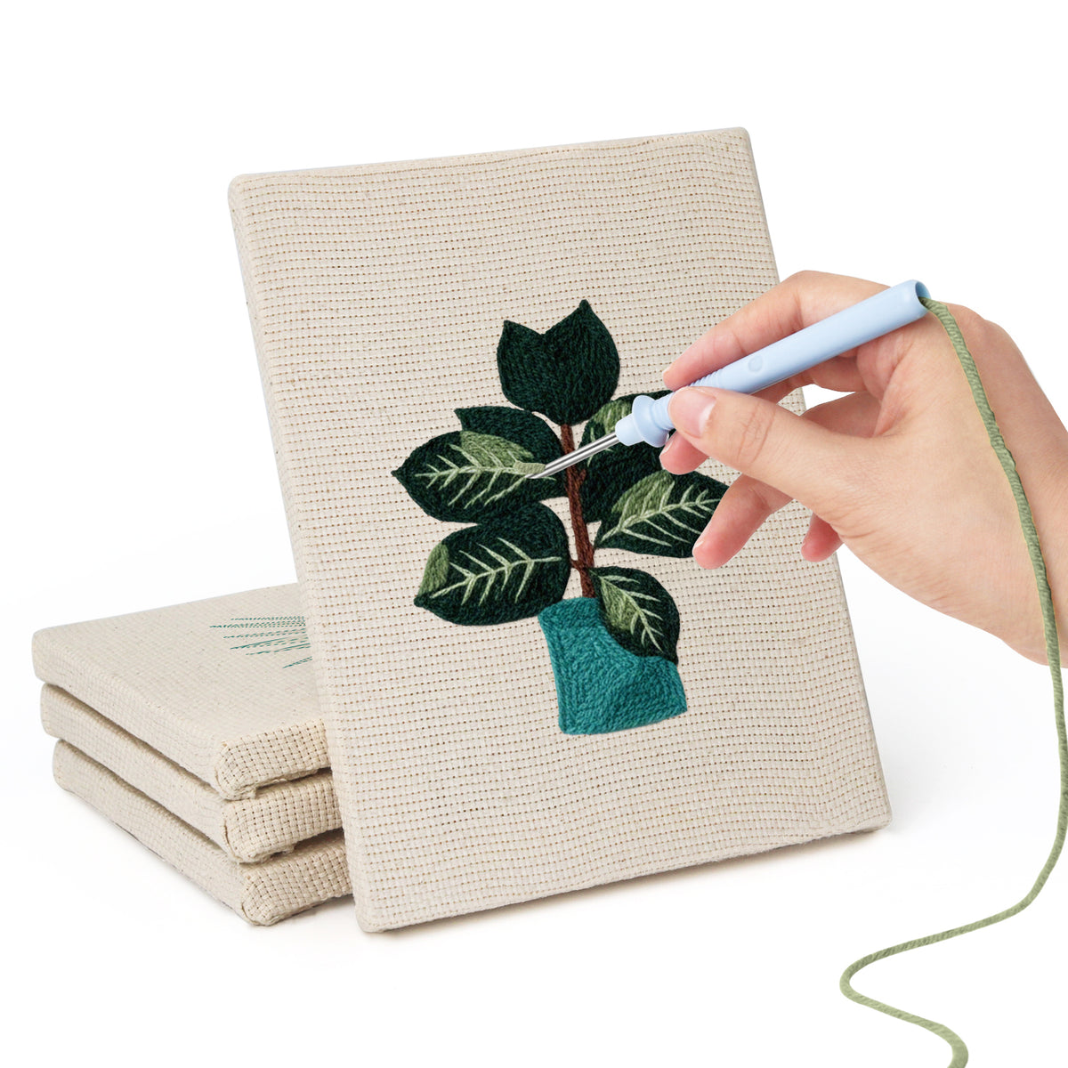 Hand punching one of the Teal Pot Greens mini canvases