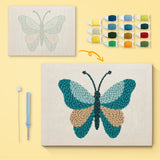 Teal Sand Butterfly canvas before and after punching, with the threads and tools