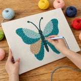 Punching the Teal Sand Butterfly design with the punch needle