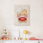 Finished Teddy Bear Chef punch needle canvas on a wall