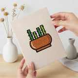Hand holding a finished Terracotta Succulents mini canvas