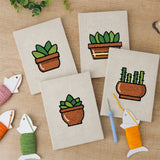 The four finished Terracotta Succulents mini canvases laid out on a table