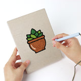 Punching a Terracotta Succulents mini canvas with the punch needle