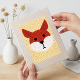 Hand holding a finished Terrier and Fox mini canvas