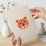 Hand holding a finished Tiger Cub Faces mini canvas