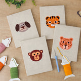 The four finished Tiger Cub Faces mini canvases laid out on a table