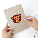 Punching a Tiger Cub Faces mini canvas with the punch needle