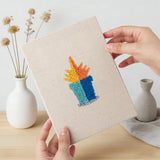 Hand holding a finished Tiny Cactus Garden mini canvas