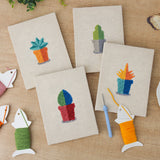 The four finished Tiny Cactus Garden mini canvases laid out on a table