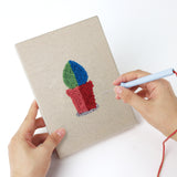 Punching a Tiny Cactus Garden mini canvas with the punch needle