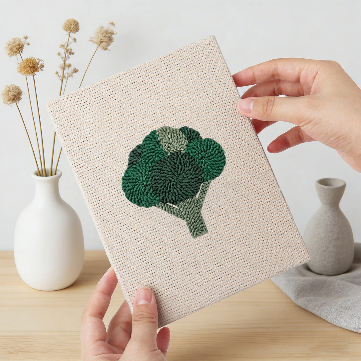 Hand holding a finished Tomato and Broccoli mini canvas