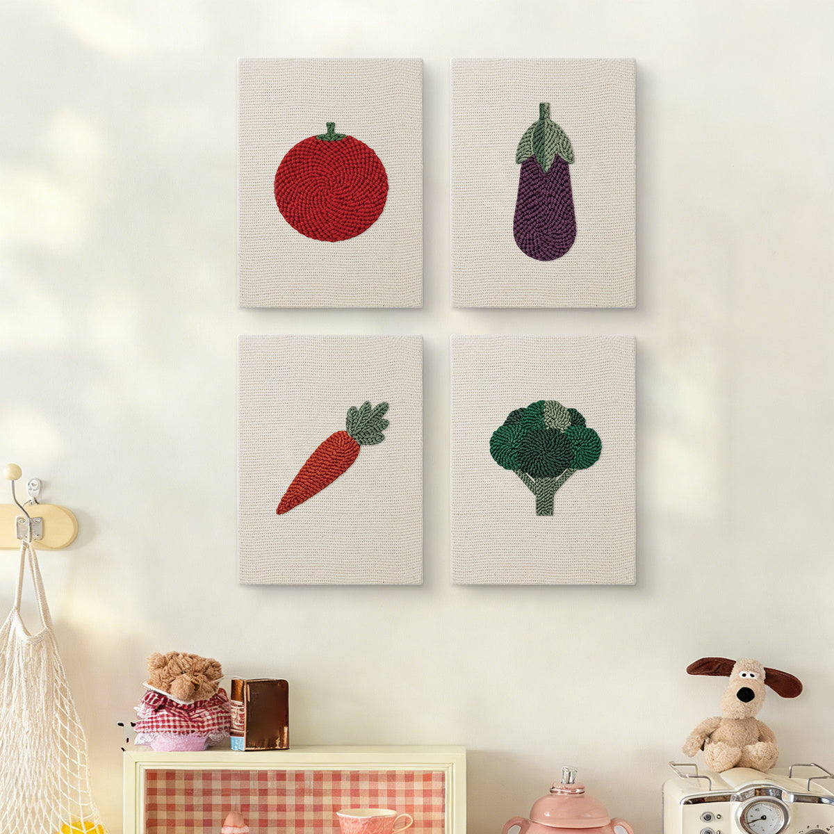 The four Tomato and Broccoli mini canvases on a wall above a shelf