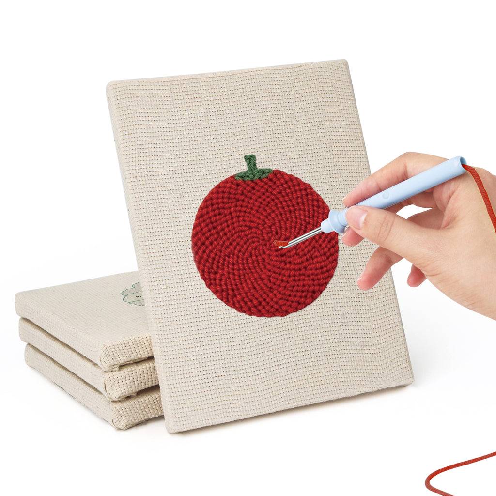 Hand punching one of the Tomato and Broccoli mini canvases