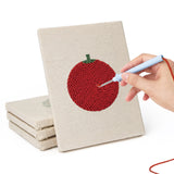Hand punching one of the Tomato and Broccoli mini canvases