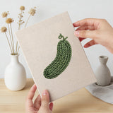 Hand holding a finished Tomato and Leek mini canvas