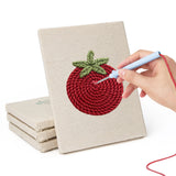 Hand punching one of the Tomato and Leek mini canvases