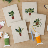 The four finished Trailing Ivy Pots mini canvases laid out on a table