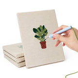 Hand punching one of the Trailing Ivy Pots mini canvases