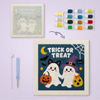 Trick or Treat Ghosts canvas before and after punching, with the threads and tools