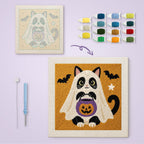 Tuxedo Cat Ghost canvas before and after punching, with the threads and tools