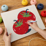 Punching the Two Red Tomatoes design with the punch needle