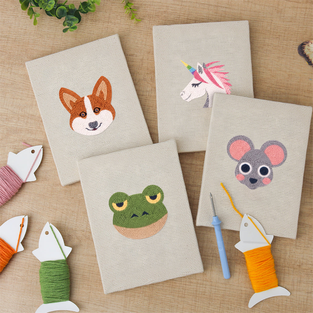 The four finished Unicorn and Frog mini canvases laid out on a table